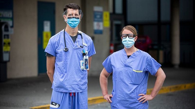 Healthcare Workers Standing Proud in Front of Hospital