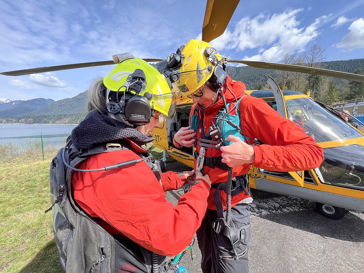 Doug harness check beside helicopter