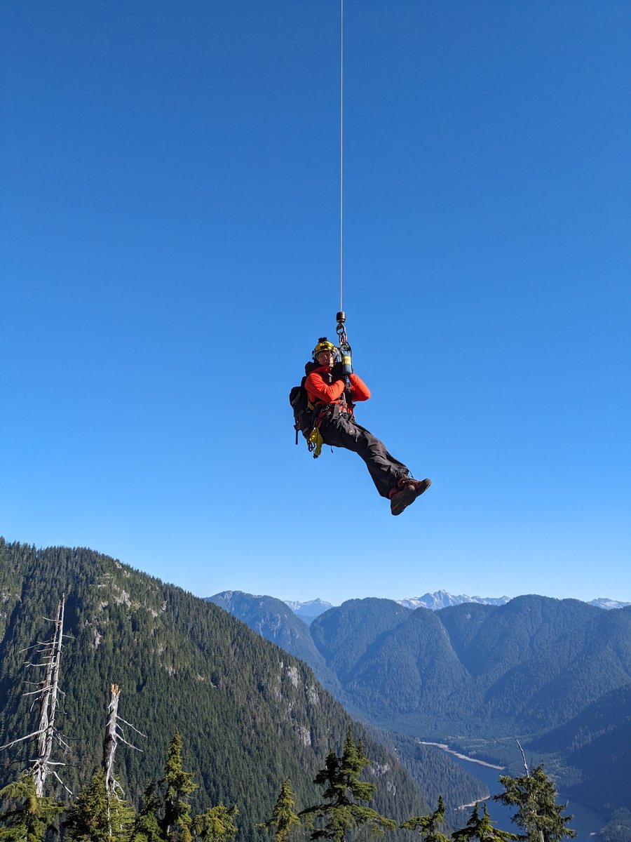 Dr. Brown hanging under the Helicopter