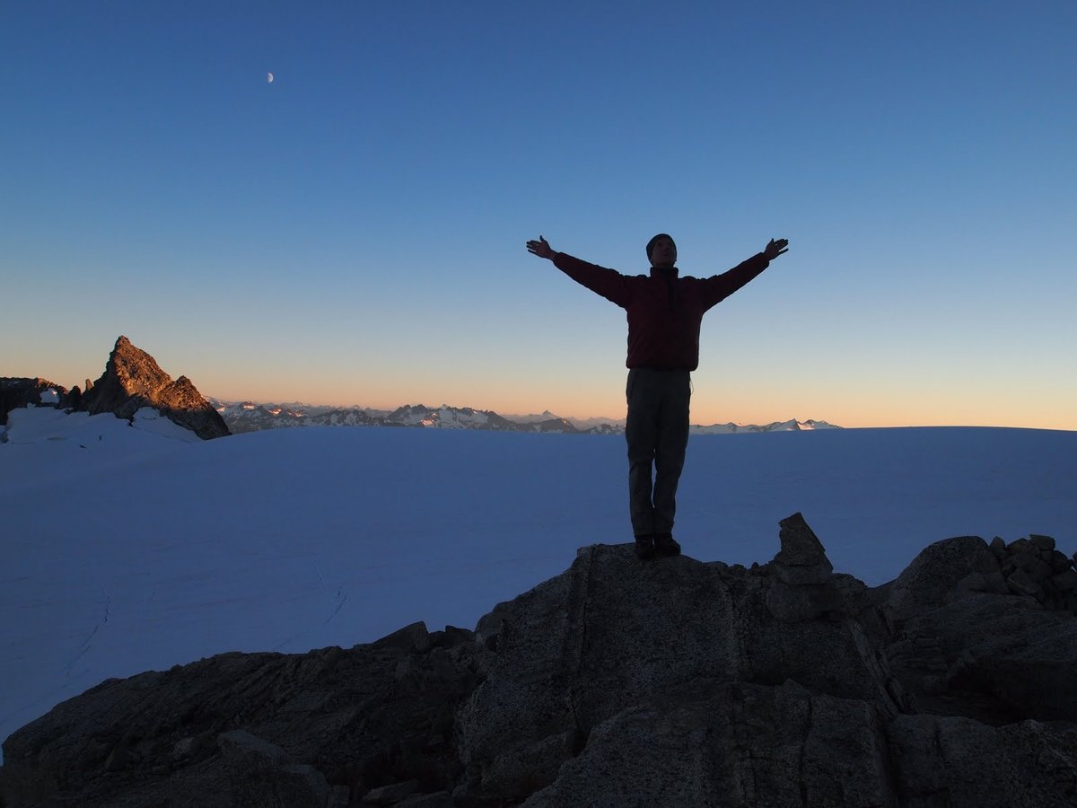 Mountain sunset; Doug with arms raised