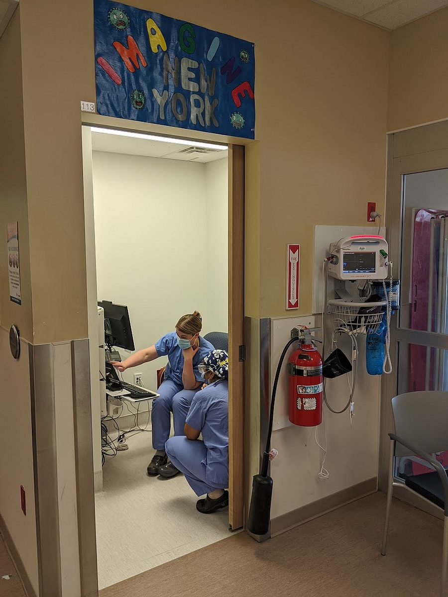Nurses Collaborating Under New York Sign